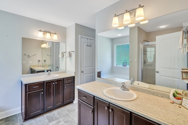 bathroom with vanity and separate shower and tub