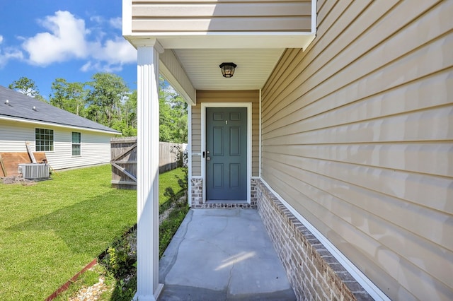 property entrance featuring central AC and a lawn