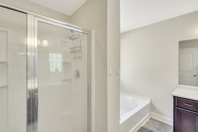 bathroom with vanity and independent shower and bath