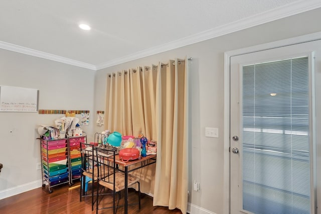 dining area featuring dark hardwood / wood-style floors and ornamental molding