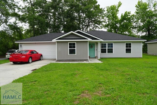 613 Macon St, Ludowici, GA 31316 - ranch-style home featuring driveway, an attached garage, and a front yard