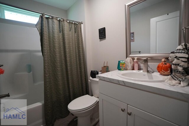 613 Macon St, Ludowici, GA 31316 - full bath featuring toilet, vanity, and shower / bathtub combination with curtain