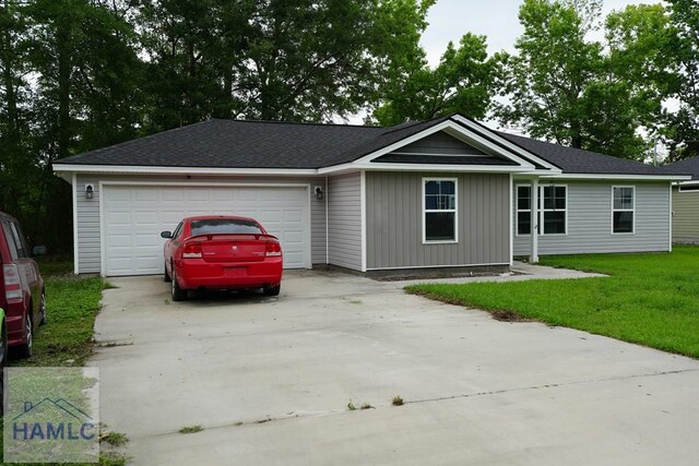 613 Macon St, Ludowici, GA 31316 - single story home featuring concrete driveway, a garage, and a front yard