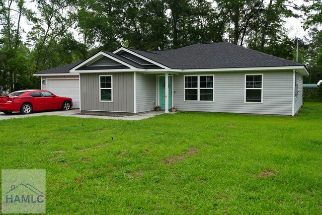 613 Macon St, Ludowici, GA 31316 - ranch-style home featuring a garage, a front yard, a shingled roof, and driveway