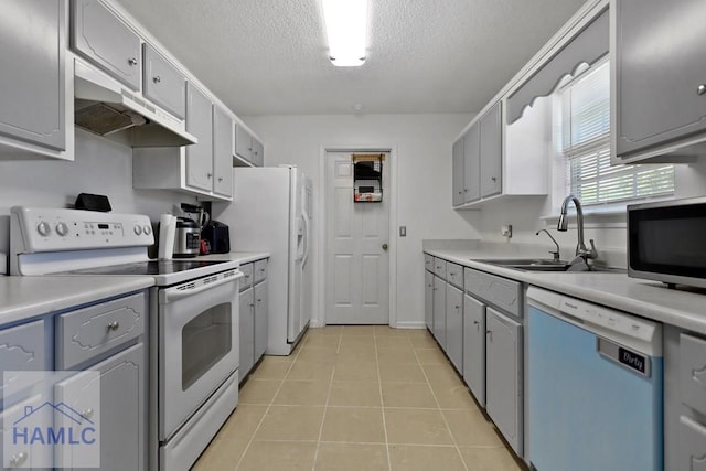 926 Poppleton Dr, Hinesville, GA 31313 - kitchen featuring white appliances, a sink, under cabinet range hood, gray cabinetry, and a textured ceiling