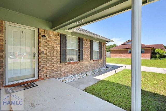 926 Poppleton Dr, Hinesville, GA 31313 - doorway to property with brick siding and a lawn