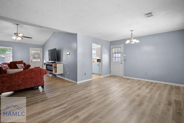 926 Poppleton Dr, Hinesville, GA 31313 - living room featuring a textured ceiling, a chandelier, light wood-style floors, baseboards, and ceiling fan
