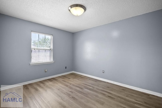 926 Poppleton Dr, Hinesville, GA 31313 - unfurnished room with wood finished floors, a textured ceiling, and baseboards