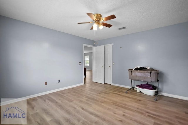 926 Poppleton Dr, Hinesville, GA 31313 - unfurnished bedroom with wood finished floors, baseboards, a textured ceiling, and ceiling fan