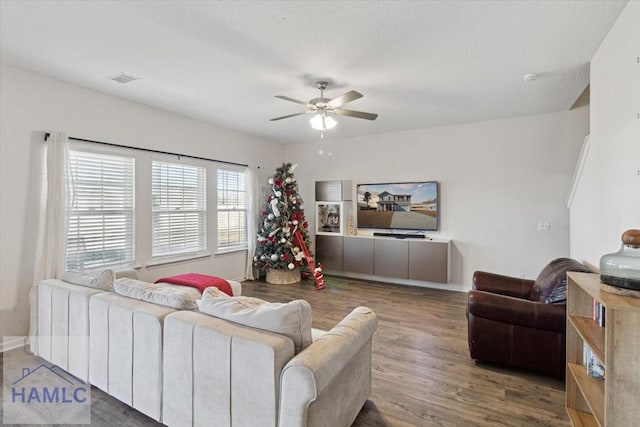 living room featuring hardwood / wood-style floors and ceiling fan