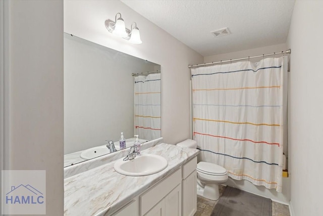 full bathroom featuring shower / tub combo with curtain, vanity, a textured ceiling, and toilet