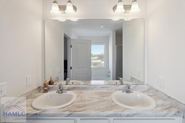 bathroom featuring vanity and a chandelier