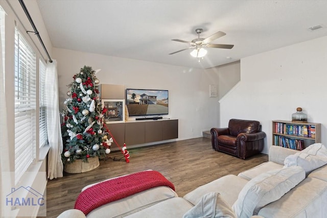 living room featuring wood-type flooring and ceiling fan