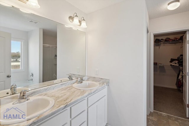 bathroom featuring vanity, shower with separate bathtub, and a textured ceiling