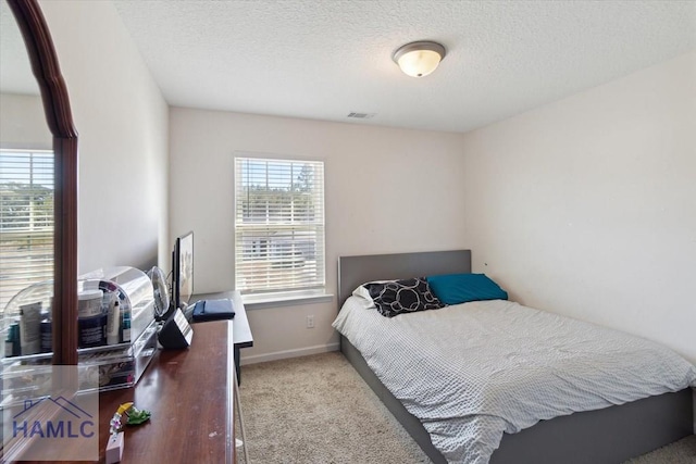 carpeted bedroom featuring a textured ceiling