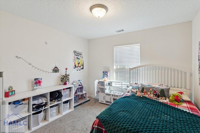 bedroom featuring carpet flooring and a textured ceiling