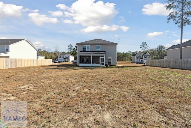 rear view of house featuring a lawn