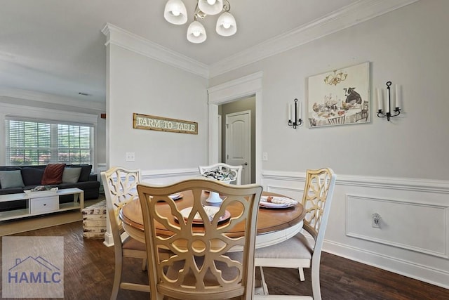 1653 Hawthorne Rd, Townsend, GA 31331 - dining room with dark wood-type flooring, ornamental molding, a chandelier, and wainscoting
