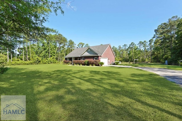 1653 Hawthorne Rd, Townsend, GA 31331 - view of front of property featuring a front yard, driveway, and an attached garage
