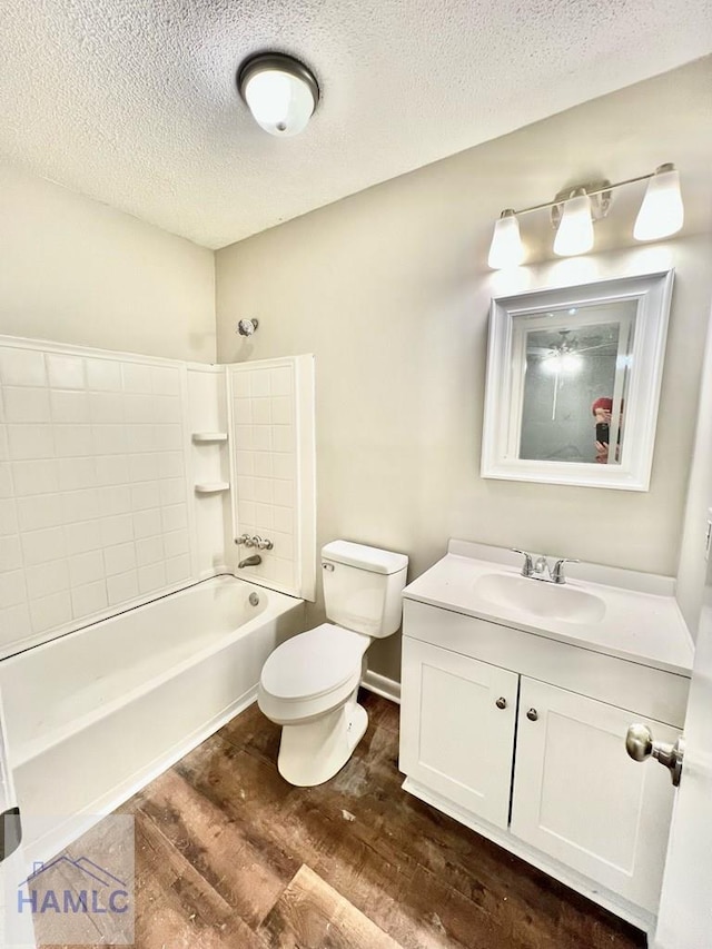 full bathroom with vanity, toilet, a textured ceiling, wood-type flooring, and tub / shower combination