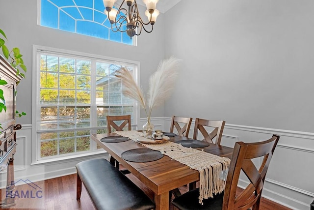 dining room with a healthy amount of sunlight, dark hardwood / wood-style flooring, and a chandelier