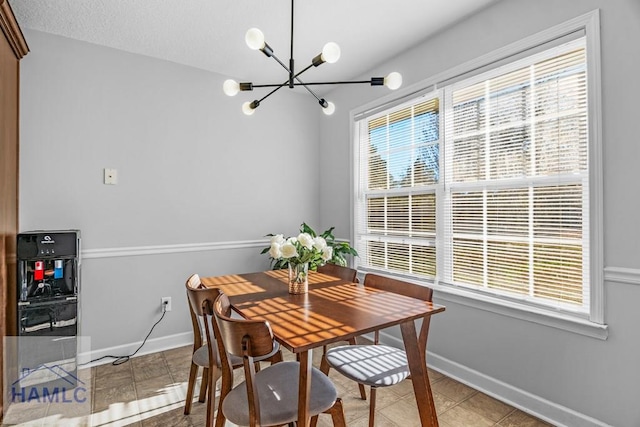 tiled dining area featuring an inviting chandelier