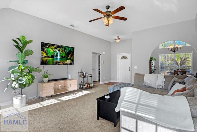 living room with light carpet, ceiling fan with notable chandelier, and lofted ceiling