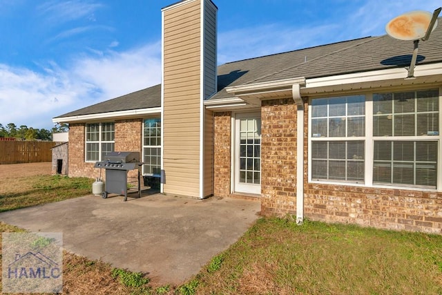 rear view of property with a yard and a patio