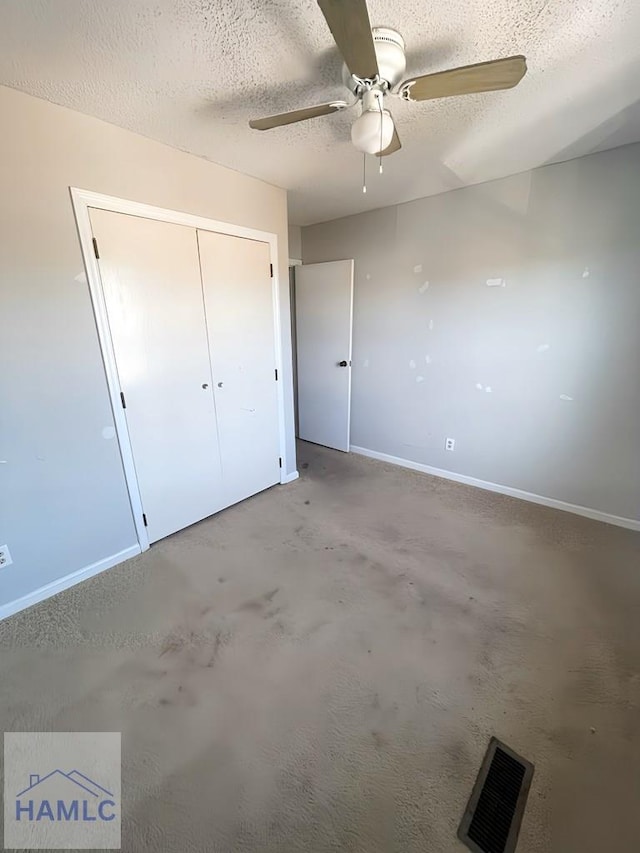 unfurnished bedroom with a textured ceiling, a closet, and ceiling fan