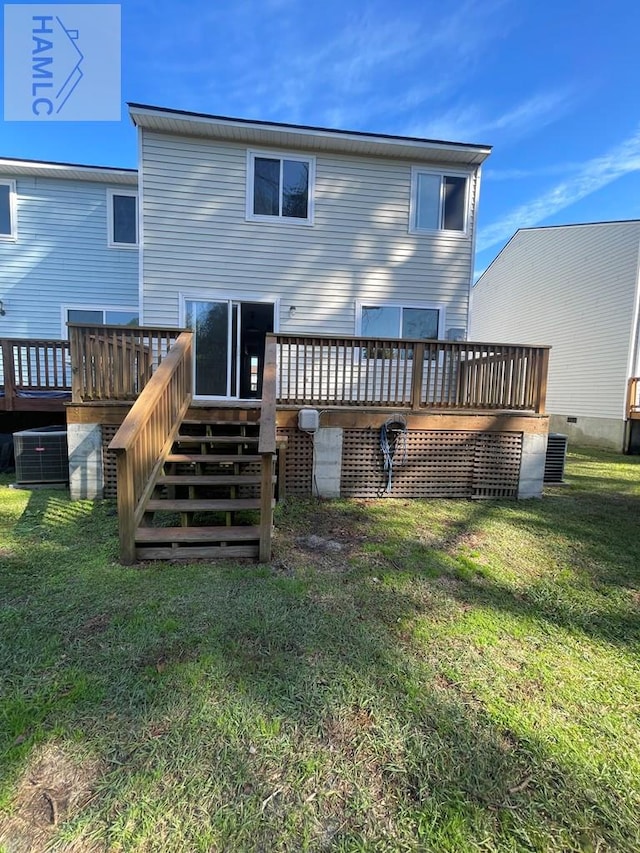 back of property featuring a yard, central AC, and a wooden deck