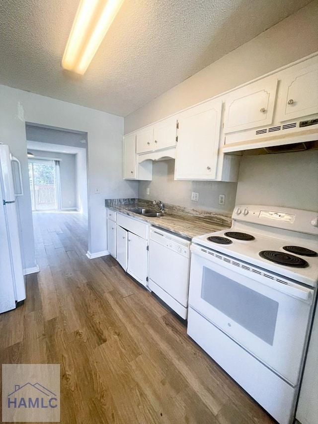 kitchen with a textured ceiling, white appliances, sink, light hardwood / wood-style flooring, and white cabinetry