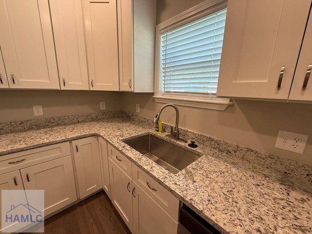 34 Pear St, Ludowici, GA 31316 - kitchen with white cabinets, light stone countertops, and dark wood-style flooring