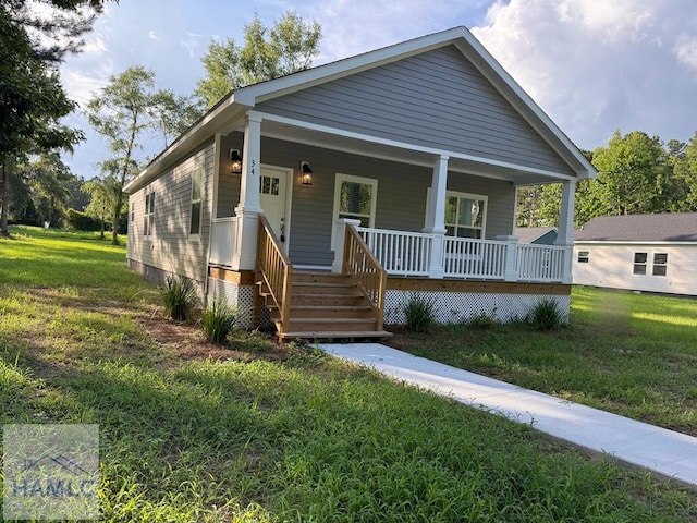 34 Pear St, Ludowici, GA 31316 - view of front of house with a porch and a front yard