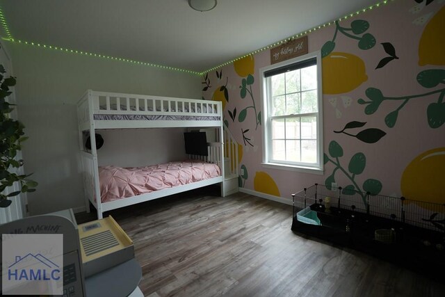 21 Oak Ridge Cemetery Rd SW, Ludowici, GA 31316 - bedroom with wood finished floors, multiple windows, baseboards, and wallpapered walls
