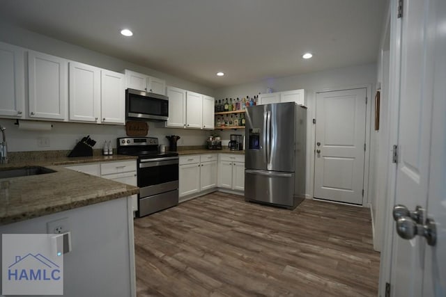 21 Oak Ridge Cemetery Rd SW, Ludowici, GA 31316 - kitchen featuring stainless steel appliances, a sink, light stone countertops, white cabinetry, and recessed lighting