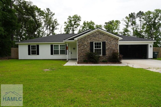 21 Oak Ridge Cemetery Rd SW, Ludowici, GA 31316 - ranch-style house with an attached garage, concrete driveway, and brick siding