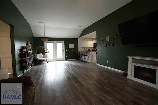 21 Oak Ridge Cemetery Rd SW, Ludowici, GA 31316 - living room with vaulted ceiling, dark wood-style flooring, baseboards, and a fireplace