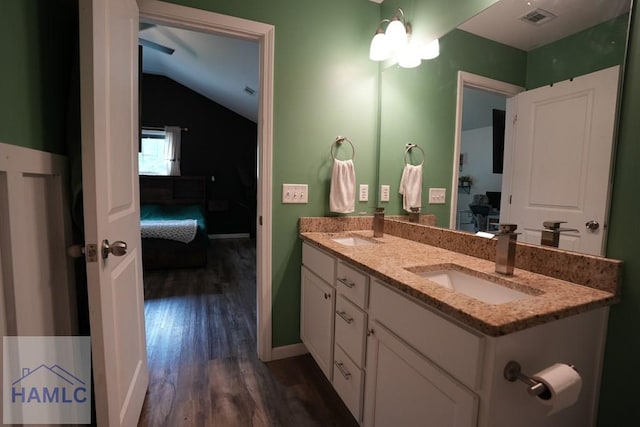 21 Oak Ridge Cemetery Rd SW, Ludowici, GA 31316 - bathroom featuring wood finished floors, ensuite bathroom, double vanity, lofted ceiling, and baseboards