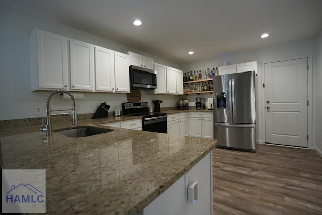 21 Oak Ridge Cemetery Rd SW, Ludowici, GA 31316 - kitchen featuring stainless steel appliances, a sink, light stone countertops, white cabinets, and recessed lighting