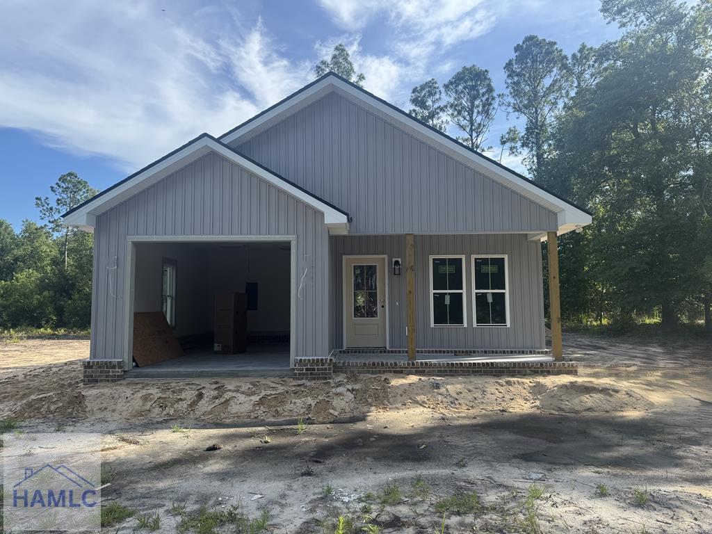 158N Deborah Cir, Jesup, GA 31546 - view of front facade with an attached garage, a porch, and board and batten siding