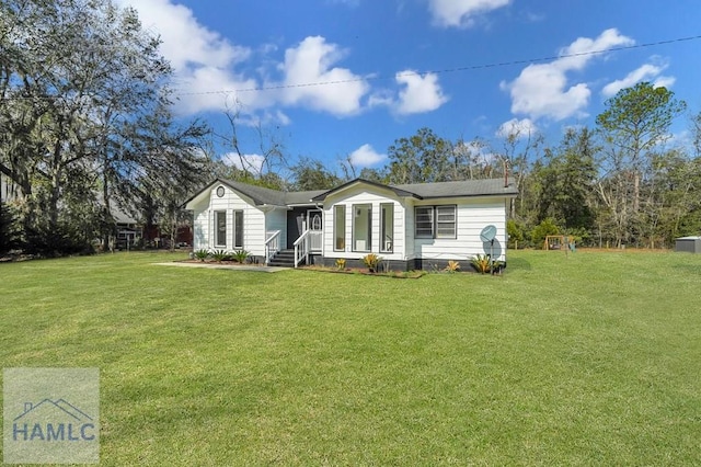 rear view of property with a lawn