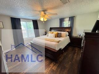 bedroom with dark hardwood / wood-style flooring, ceiling fan, and a textured ceiling