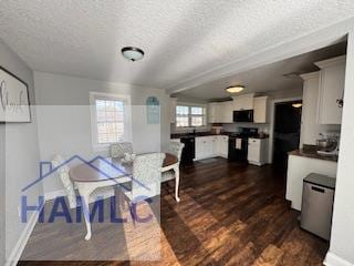 dining room with dark hardwood / wood-style floors and a textured ceiling