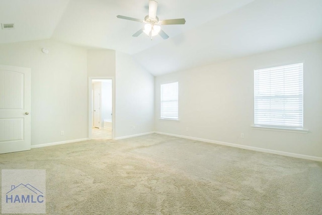 spare room with light colored carpet, ceiling fan, and lofted ceiling