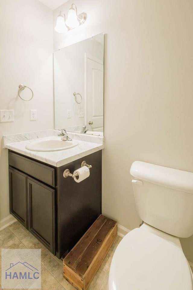 bathroom featuring tile patterned floors, vanity, and toilet