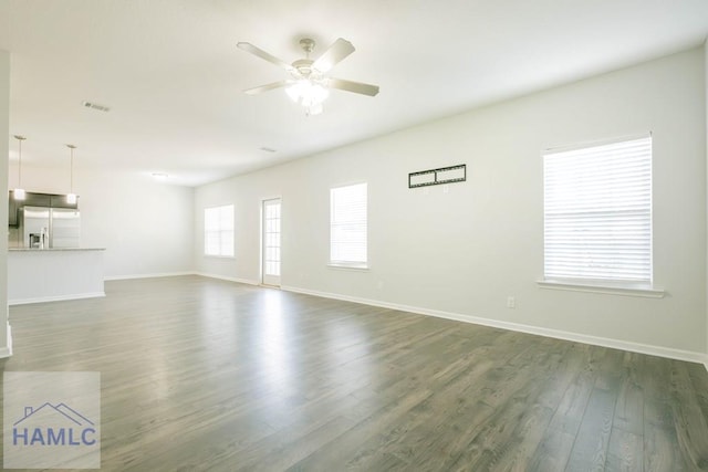 unfurnished living room with dark hardwood / wood-style floors and ceiling fan