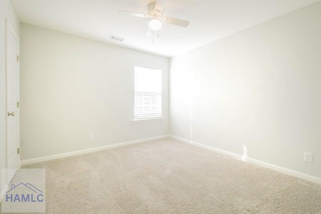 carpeted empty room featuring ceiling fan