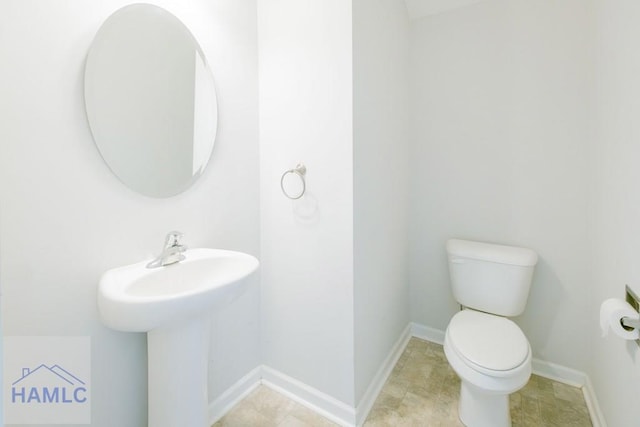 bathroom with tile patterned flooring, toilet, and sink