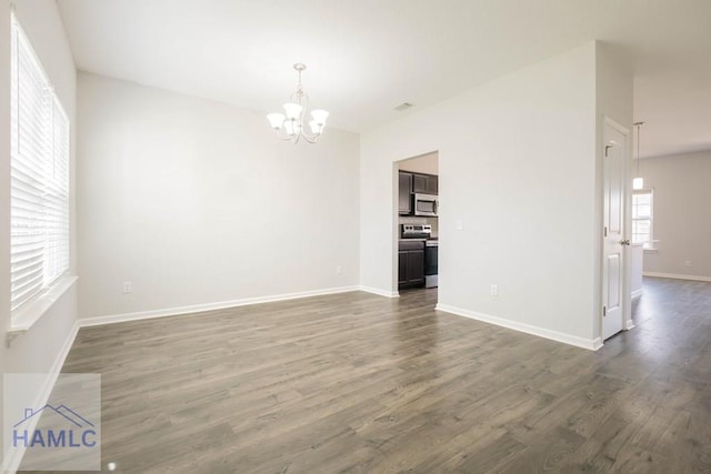 interior space featuring a notable chandelier and dark hardwood / wood-style floors