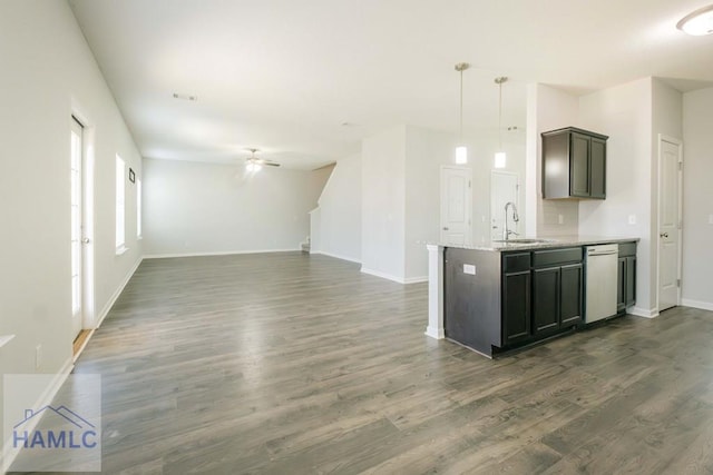 kitchen featuring light stone counters, dark brown cabinetry, ceiling fan, dark wood-type flooring, and hanging light fixtures